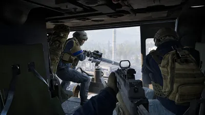 Soldiers manning a door gun on a helicopter
